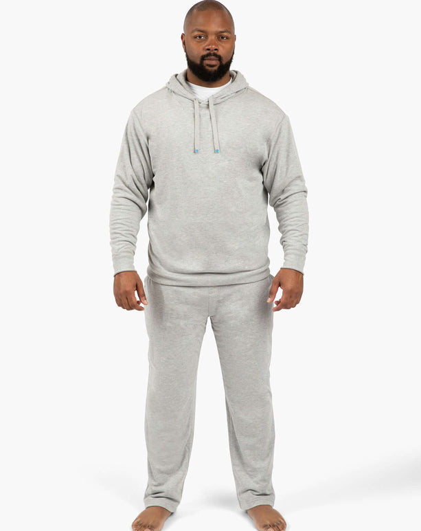 Active man in gray DudePants hoodie and sweatpants, showcasing comfort and style for gym, beach, and casual wear.