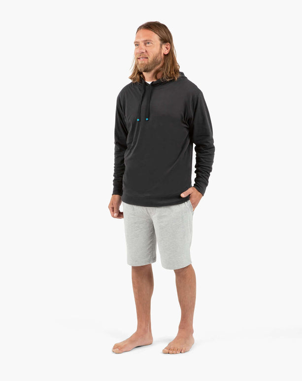 DudeShorts model wearing a black hoodie and gray shorts, embodying active lifestyle and comfort.