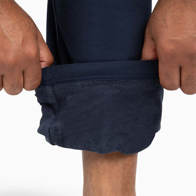 Close-up of relaxed hem of black sweatpants men with absorbent towel lining, part of The Pants.