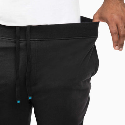 The Pants in black, showcasing extra deep pockets and premium comfort waistband for men's sweatpants.