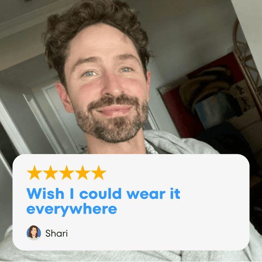 A man smiling while wearing The DudeRobe, showcasing its comfort and stylish design.