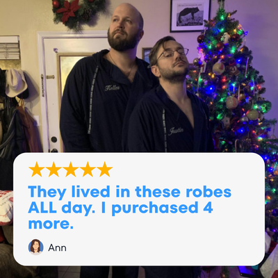 Two men wearing The DudeRobe, a stylish mens hooded bathrobe, standing by a Christmas tree.