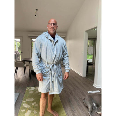 The DudeRobe - Men's Luxury Hooded Bathrobe worn by a man in a modern home setting.
