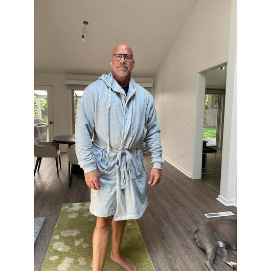 The DudeRobe - Men's Luxury Hooded Bathrobe worn by a man in a modern home setting.