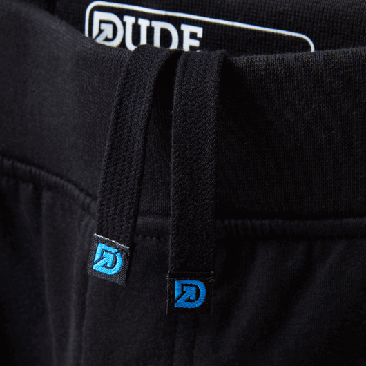 The Pants: Close-up of premium drawstrings on black sweatpants men with absorbent towel lining and logo'd details.
