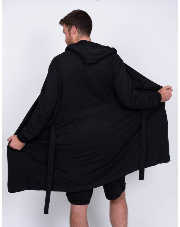 Man wearing a black DudeRobe, showcasing the modern design and comfortable fit for lounging and relaxation.