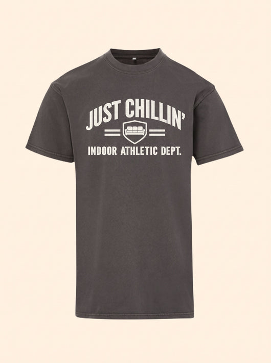 Just Chillin' Indoor Athletic Dept. tee in Ash Black with a cream couch crest print on the chest