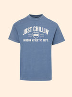 Just Chillin' Indoor Athletic Dept. tee in Oxford Blue with a cream couch crest print on the chest