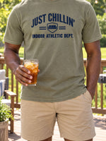 Man on a backyard deck wearing the DudeRobe Just Chillin' tee in Olive Branch