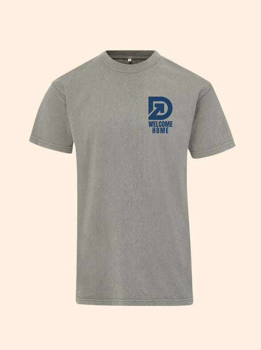 Welcome Home tee in Hazy Days with a navy DudeRobe D logo and Welcome Home printed on the left chest