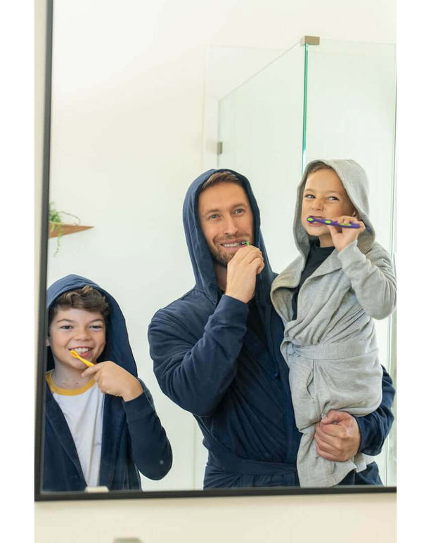 Family fun in DudeRobes, modern hooded bathrobes for men and kids, enjoying morning routines together.