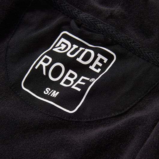 Close-up of IndoorCamo™ Limited Edition DudeRobe tag, showcasing the brand and size details.