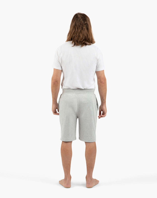 Man standing from behind in grey DudeShorts and a white t-shirt, showcasing comfort and style.