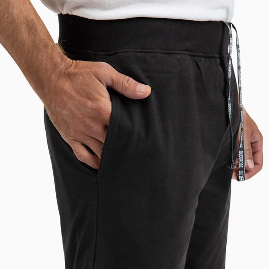 Close-up of a man wearing men's shorts with a hand in the pocket showing comfort and style.