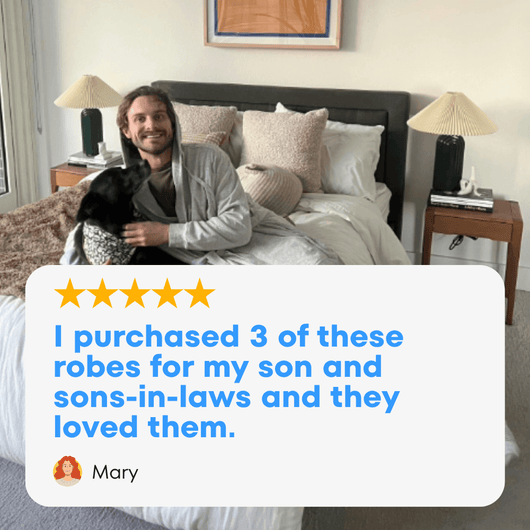 Man wearing a cozy american flag robe with a dog, showcasing customer satisfaction with the All-American robe.