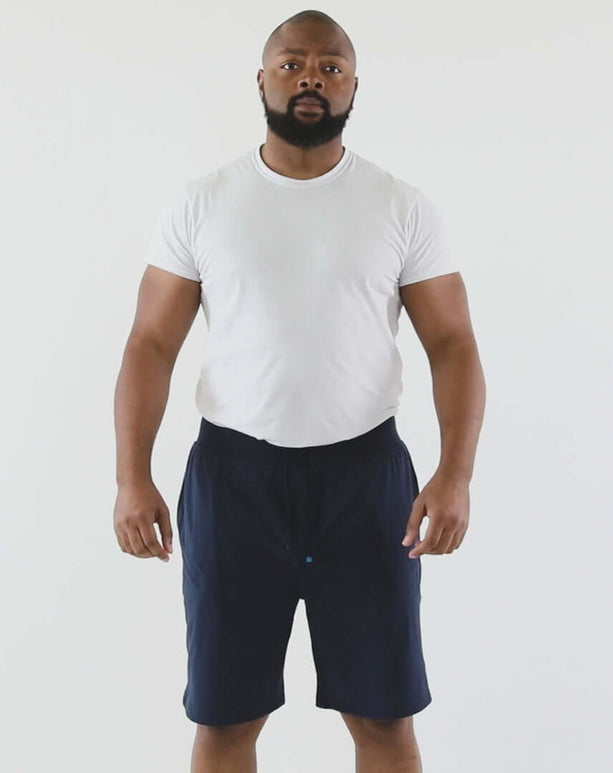 DudeShorts model showcasing navy shorts with comfortable fit, deep pockets, and premium waistband for active lifestyles.