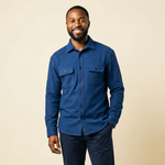 Smiling man wearing The 1-Second Flannel, a magnetic button shirt in blue color.