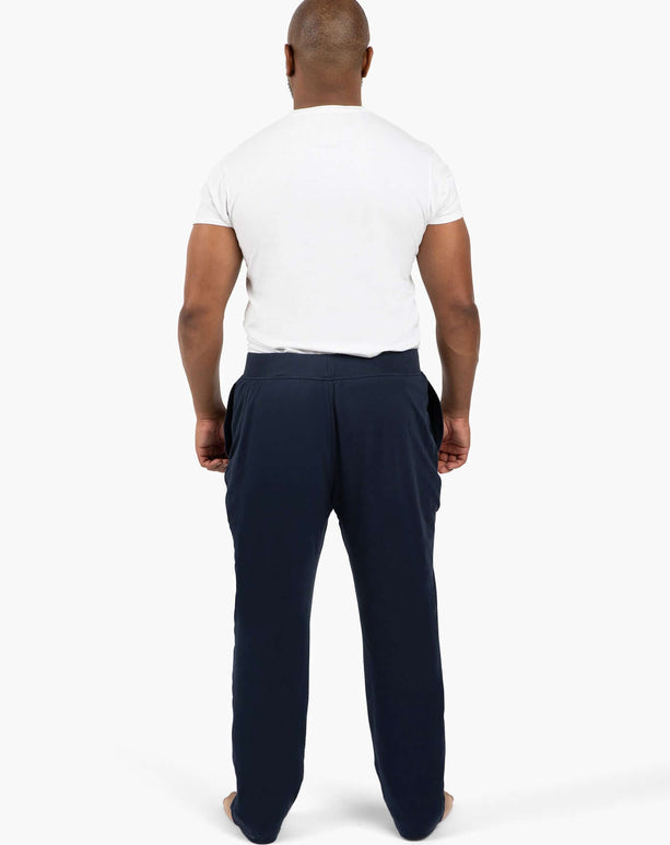 Man wearing DudePants from the back, showcasing relaxed fit and deep pockets, perfect for active lifestyles.