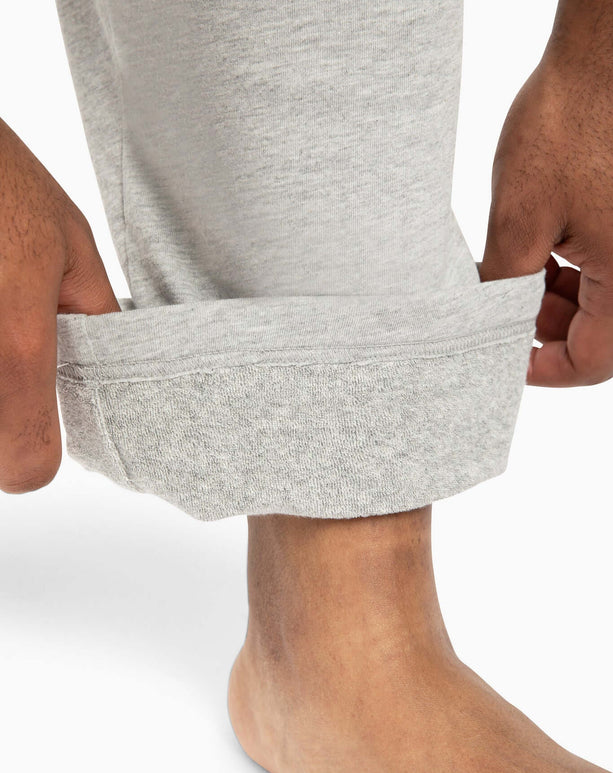 Close-up of a person adjusting the cuff of DudePants, showcasing the towel lining and relaxed fit for comfort.