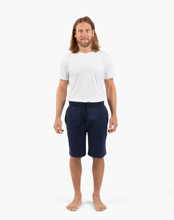 Man wearing DudeShorts and a white t-shirt, showcasing comfort and style for active lifestyles.