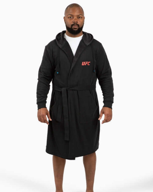 Model wearing a black UFC DudeRobe, showcasing comfortable UFC merch ideal for fans.