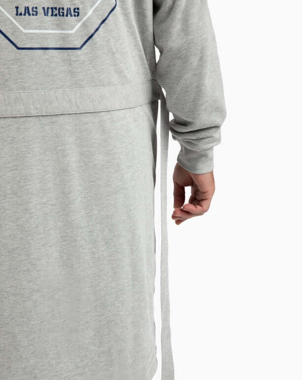 Close-up of a man tying the belt on a grey DudeRobe with 'Las Vegas' design.