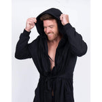 Man smiling in UFC DudeRobe Black, showcasing a modern twist on traditional bathrobes, perfect for UFC merch fans.