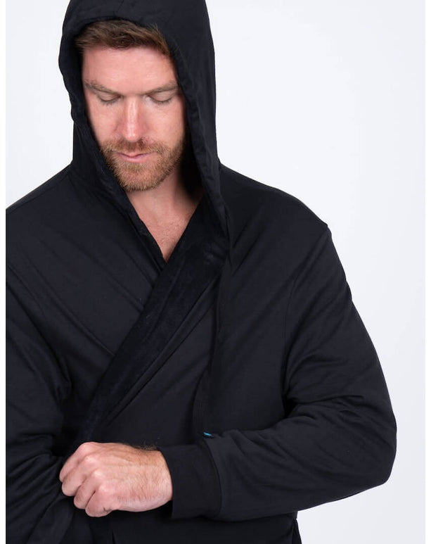 Man wearing the stylish black DudeRobe with a hood, perfect for lounging and daily comfort.