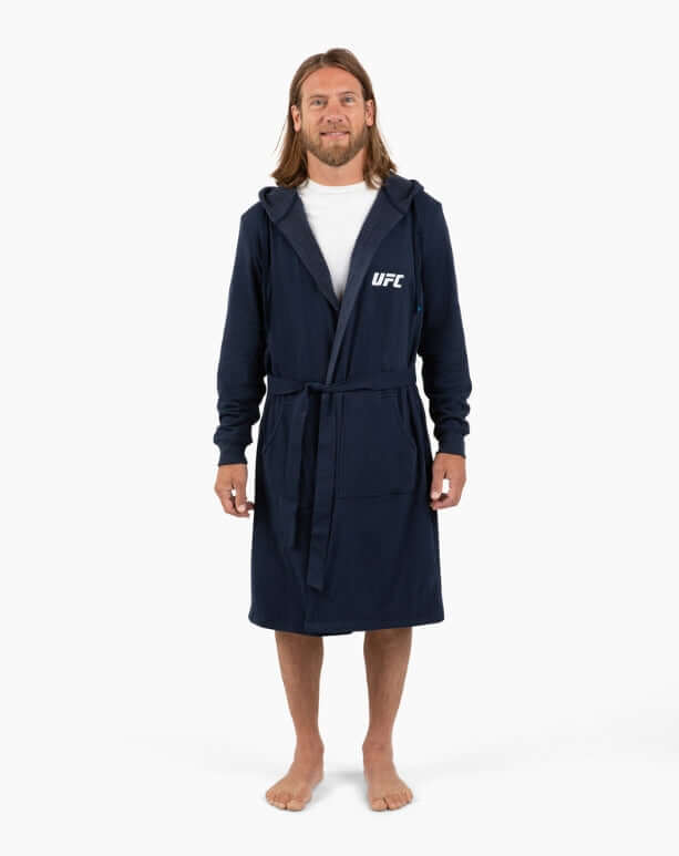 Man wearing UFC DudeRobe in navy, showcasing modern style for lounging and comfort after a shower.