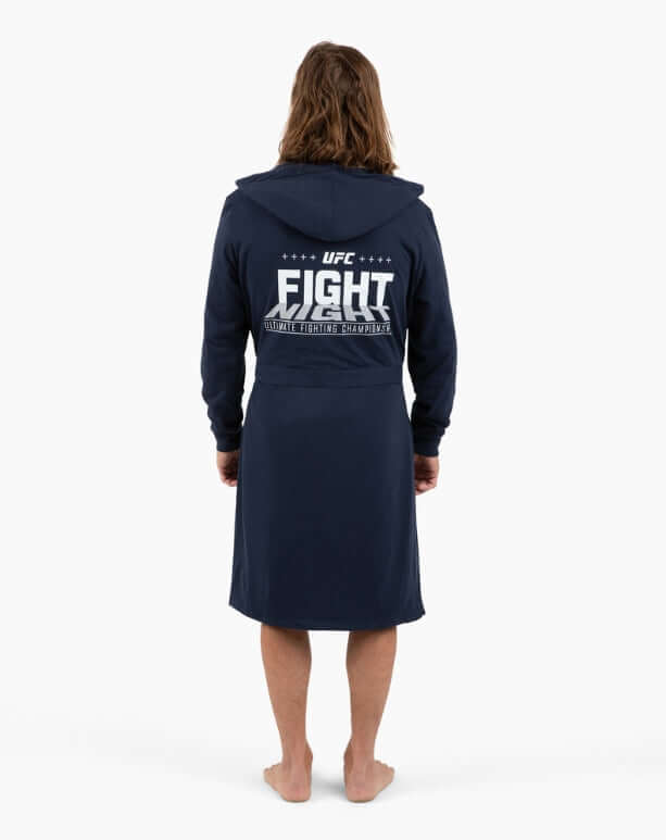 Man wearing a navy UFC DudeRobe, showcasing the modern robe's design and comfort from the back.