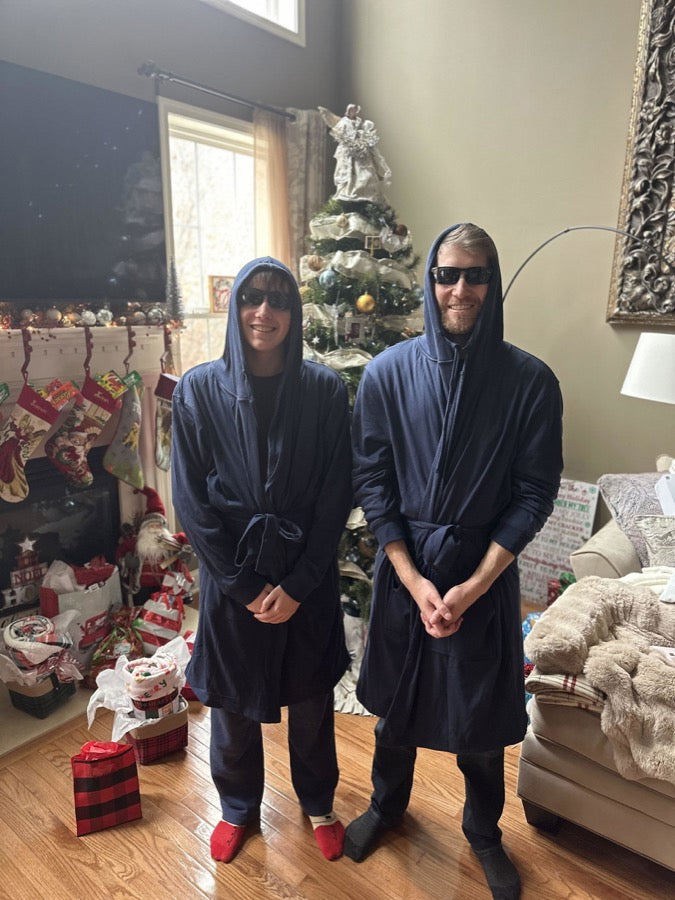 Two sons wearing navy DudeRobes on Christmas morning